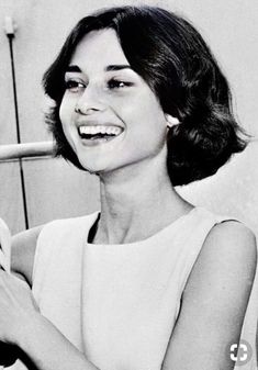 a black and white photo of a woman brushing her teeth