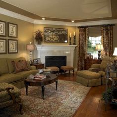 a living room filled with furniture and a fire place in the middle of a room