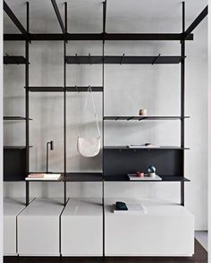 a room with shelves and hanging items on the wall