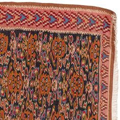 an old rug with colorful designs and fringes on the edges, in various colors