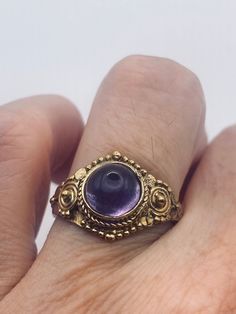 Deep purple amethyst stone  Lovely vintage golden bronze setting Size 7.5  Our jeweler can custom re size this for a $20 fee.  All rings are shipped in a nice gift box.   Check out our over a THOUSAND great reviews Engraving is $4 per letter and is not always perfect depending on the piece. It can take a few days if the jeweler is busy. This is payable to Paypal Judithsltd@gmail.com Vintage Amethyst Ring Gold, Bohemian Jewelry With Bezel Setting As Gift, Vintage Amethyst Ring With Stone Setting, Vintage Gold Rings With Stone Setting, Gold Heirloom Amethyst Gemstone Ring, Vintage Gold Crystal Ring With Stone Setting, Vintage Amethyst Crystal Ring With Gemstone, Antique Round Crystal Gemstone Ring, Unique Antique Finish Rings As Gift