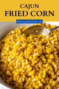 a white bowl filled with corn on top of a table