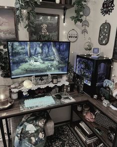 a desk with two computer monitors on top of it and various decorations around the room