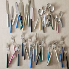 there are many forks and spoons on the table