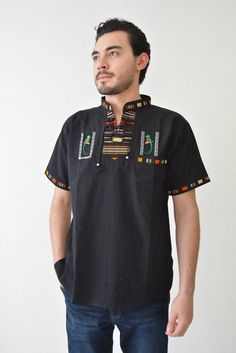 El Quetzal embroidered shirt, Guatemalan men's handmade shirt handwoven fabric accents the neck, sleeves, and across the shoulders in the back. A draw string neck that opens down to the mid chest. These comfortable relaxed-fit shirts are made with thick cotton that breathes. They have a great vintage look to them reminiscent of the "boho" style of the 70's.  SIZING Measurements are provided in the section of pictures. FEATURES: *Soft and comfortable Guatemalan T-shirts handmade, loomed with contrasting trim. *Sleeve length:  Short sleeve *Breathable fabric, 100% Guatemalan cotton.    *      They are fantastic for all types of weather, especially those hot summer days. CARE INSTRUCTIONS:  Hand wash in cold water, do not soak, and hang dry. PLEASE NOTE: ■This shirt will be ready to ship in 2 Traditional Fit Cotton Summer Tops, Traditional Fit Cotton Tops For Summer, Traditional Black Embroidered Shirt, Traditional Fit Short Sleeve Shirt, Casual Embroidered Shirt Traditional Fit, Casual Embroidered Shirt With Traditional Fit, Traditional Cotton Festival Shirt, Embroidered Traditional Fit Summer Tops, Embroidered Traditional Fit Top For Summer