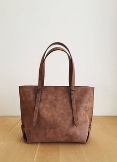 "This tote bag is made of high quality vegan leather in brown. It is soft and lightweight but durable. It stands on its own. It has a rustic, distressed look. It has one interior zipper pocket. Straps are adjustable. Measurements: 32 x 30 x 15 cm IMPORTANT! Your orders between 7-25 August will be shipped on August 28. Delivery takes 2-5 days to the US, Canada, Australia and Europe; in 3-7 days to rest of the world after shipping. For other color options you can check \"Totes\" section: http://et