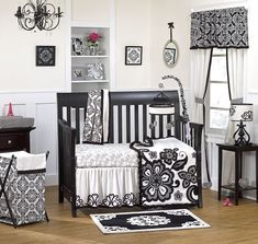 a baby crib with black and white decor