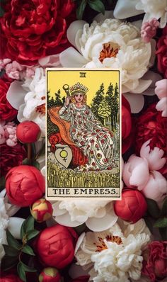 a tarot card surrounded by flowers and peonies with the queen of cups