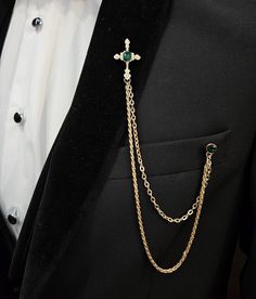 The perfect formal wear accessory. This elegant chain lapel and gemstone brooch pin set features a dazzling chain and a luxurious gemstone brooch  that add that perfect touch of dapper to your entire look.  This piece is a welcome addition to refine your over-all aesthetic. Luxury Gold Lapel Pin For Party, Elegant Chain Lapel Pin For Formal Occasions, Elegant Formal Lapel Pin With Chain, Elegant Chain Brooch For Gift, Elegant Lapel Pin With Chain As Gift, Elegant Gold Lapel Pin For Party, Gold Brooches With Chain For Party, Gold Chain Brooches For Party, Gold Chain Brooch For Party