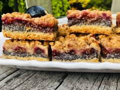 a white plate topped with blueberry crumb bars