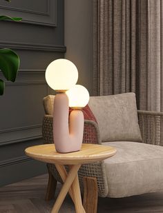 a table with a lamp on it next to a chair