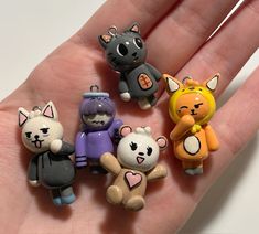 a hand holding five small toy animals on it's palm