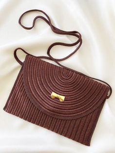 Designer: Nina Ricci Material: Polyester and goldplated metal Colour: Brown Hardware: Gold Condition: Mint condition Highth: 15 cm. Width: 22 cm. Depth: 1 cm. Formal Brown Woven Bag, Formal Brown Woven Bags, Elegant Brown Woven Shoulder Bag, Vintage Brown Rectangular Evening Bag, Vintage Brown Evening Bag, Vintage Gold Crossbody Shoulder Bag, Vintage Brown Woven Bag, Brown Vintage Woven Shoulder Bag, Vintage Brown Woven Shoulder Bag