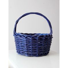 a blue basket sitting on top of a white table