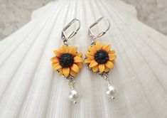 Featuring Hand sculpted Red Yellow Sunflower Earrings. Perfect for Sunflower wedding theme, or sunflower jewelry collection. All Sunflower collection: https://www.etsy.com/shop/MorningHeirloom?ref=seller-platform-mcnav&search_query=sunflower Details: - Sunflower Flower size is approximately 17-18mm. - Glued on Filigree. - 6mm white Swarovski Pearls . Cream available. - The entire length is approximately 4cm. - Metal Finish available in Silver Plated, Gold plated, antiqued brass and Rose Gold Sunflower Design Jewelry For Anniversary, White Flower-shaped Jewelry With Sunflower Design, Sunflower Design Flower Jewelry For Anniversary, White Flower Jewelry With Sunflower Design, White Sunflower Design Flower Jewelry, Wedding Jewelry With Sunflower Design, Elegant Sunflower Design Flower Earrings For Gift, Yellow Jewelry With 3d Flower Details, Handmade Yellow Flower Earrings For Wedding