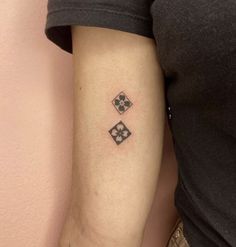 a woman with a tattoo on her arm has a black and white checkered design