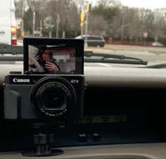 a camera sitting on the dashboard of a car