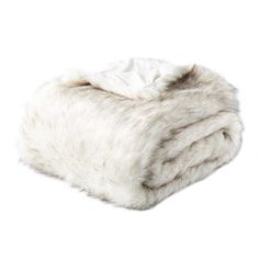 a white fur blanket folded on top of each other