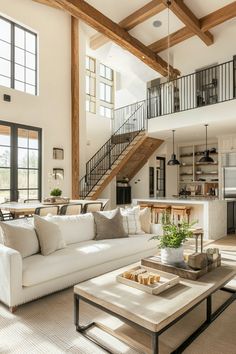 a living room filled with furniture and a stair case in the middle of the room