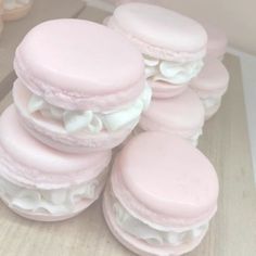 pink macaroons are stacked on top of each other