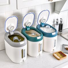 three rice cookers sitting on top of a kitchen counter