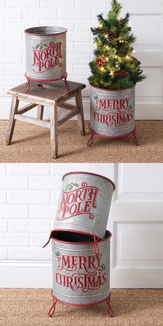 two christmas tins sitting next to each other on top of a wooden table with a tree in it