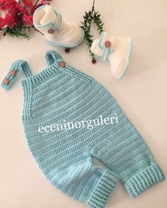 there is a knitted baby outfit and booties on the table