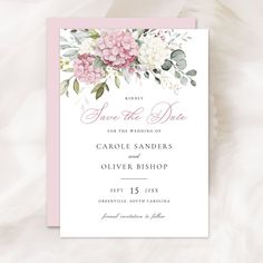 the pink and white floral wedding save the date card is displayed on a fluffy background