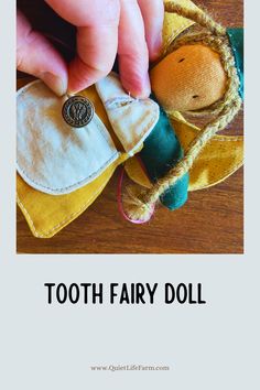 a hand is holding a tooth fairy doll on top of a wooden table with text overlay that reads, how to make a tooth fairy doll