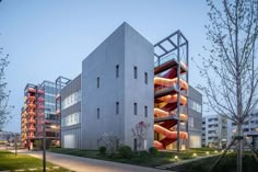 the building has multiple levels and is lit up with red lights on each level as well