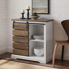 a white cabinet with drawers and plates on it