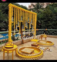 an outdoor wedding setup with yellow flowers and decorations