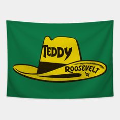 a yellow hat with the words teddy roosevelt on it, against a green background