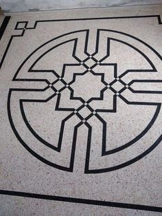 a black and white floor with an intricate design on it