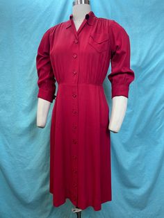 1940s W: 32" Vintage 40s Versatiler Carol Crawford Red Faille Gabardine button up collared shirt dress  Beautifully constructed vintage 40s dress under the label Versatiler by Carol Crawford. Fitted bodice with high waist and bust pockets, button up and collar. Gathered shoulders and 3/4 cuffed sleeves. Pencil skirt with two hip pockets. Dress is pull over style. Made out of faille rayon gabardine in deep carmine red color. Photographed on fit form size 8, check measurements.  MEASUREMENTS  Bust: 40" Waist: 32" Hips: 44" Bodice length: 17" Skirt length: 25" with 2" hem available Overall very good vintage condition. There is a silver shimmer residue under the arms. Presents beautifully and is wearable as is ✨ Cheap Red Collared Shirt Dress, 1940s Tea Dress, Vintage 40s Dress, 40s Dress, Collared Shirt Dress, Vintage 40s, Collared Shirt, Tea Dress, Dress Red