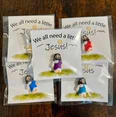 four little jesus magnets in plastic bags on a table