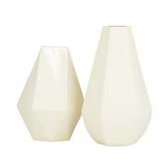 two white vases sitting next to each other on a white background, one has an upside down design