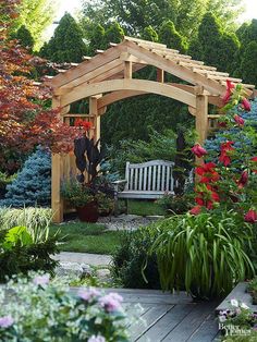 a wooden bench sitting in the middle of a garden