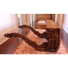 a wooden bench sitting on top of a hard wood floor next to a door way