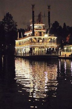 a large boat floating on top of a lake at night