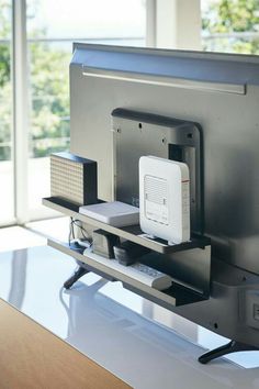 a television sitting on top of a glass table