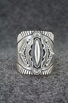 This finely crafted sterling silver ring was made by Navajo silversmith Derrick Gordon. The back is signed Derrick and stamped sterling.Size: 11Length: 1"Free shipping on all orders! We ship with USPS and always include tracking. All orders ship within a day of payment.Returns are accepted up to 30 days after you receive your order. Just send us a message. Our shop offers cash back or store credit. The item must be returned in new condition. Southwestern Silver Rings Collectible, Southwestern Silver Collectible Rings, Silver Southwestern Style Rings, Collectible Southwestern Silver Ring, Southwestern Style Untreated Silver Rings, Artisan Silver Ring With Concho, Unique Silver Ring With Concho Detail, Silver Bohemian Concho Rings, Bohemian Silver Concho Rings