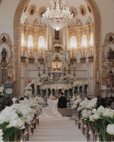 the bride and groom are sitting at the alter