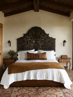 a bedroom with a large bed and wooden headboard