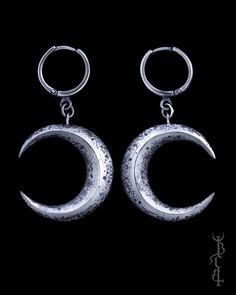 In honour of Artemis, goddess of the wilds and goddess of the moon. She who wears the crescent moon crown. These earrings feature a pair of faceted crescent moons, uniquely textured with lunar craters and crosshatched markings giving it the appearance of an ancient relic. The earrings are produced entirely in sterling silver which is treated with a dark patina then brightly polished to highlight the depth of all the intricate details. Each set of moons come on a pair of our favourite 'huggie' ea Silver Crescent Symbolic Earrings, Symbolic Silver Crescent Earrings, Silver Symbolic Crescent Earrings, Celestial Moon Phase Moon Earrings, Handmade Crescent Celestial Earrings, Celestial Crescent Moon Phase Earrings, Crescent Moon Phase Festival Earrings, Crescent Moon Phase Earrings For Festivals, Symbolic Crescent Metal Jewelry