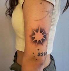 a woman's arm with a star tattoo on the left side of her body