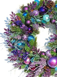 a christmas wreath with purple and blue ornaments