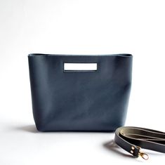 "Say hello to your new favorite handbag! She's a charming handbag with the option of including a removable black leather crossbody strap! With clean lines & modern look, the unique cutout handle adds a bit of fun.  Navy Blue Leather Black Leather Detachable Strap + Attached D Rings (optional) Brass Hardware ... * Fast & FREE USPS Shipping * Open interior pocket * Hidden magnetic closures * Measurements: 13\" wide across top, 11\" wide across bottom, 9.75\" high, 3\" deep * Optional: removable + adjustable crossbody strap with attached D rings * Made to order in Bellingham, Washington Questions? Contact me before placing your order! OPTIONAL ADD-ON Boho Adjustable Straps" Leather Bags For Women, Soft Leather Bag, Women Crossbody Bag, Favorite Handbags, Convertible Bags, Crossbody Bag Women, D Rings, Leather Bag Women, Leather Bags