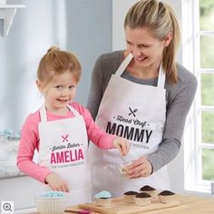 a mother and daughter making cupcakes together in the kitchen with an apron on