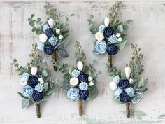 four blue and white boutions are arranged on a table